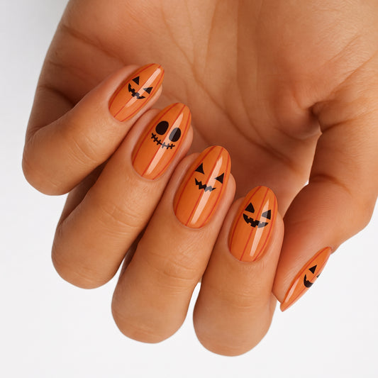 Orange glossy nail wraps with jack-o'-lantern faces, Halloween pumpkin design