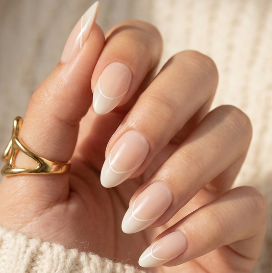 French tip press-on nails in short almond shape on hand with nude base