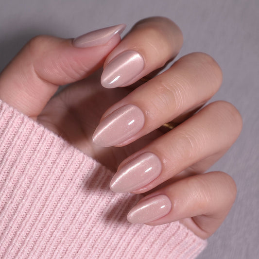 Sheer nude pink almond nails with subtle shimmer, glossy semi-cured gel finish.