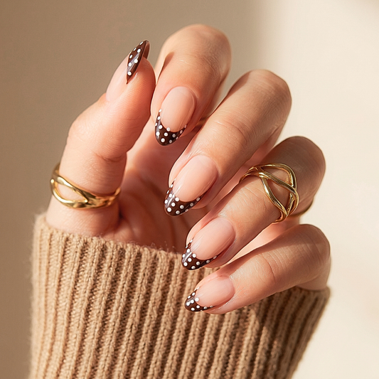 Almond press-on nails with brown French tips and white polka dot accents