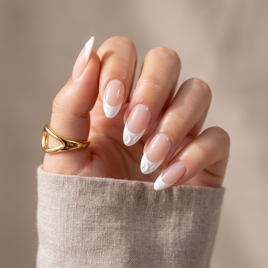 Glossy white French tip nail wraps with wavy swirl accent on nude almond nails