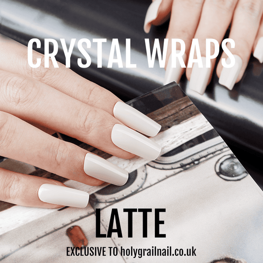Hand applying latte beige crystal nail wraps with marble design for elegant manicure