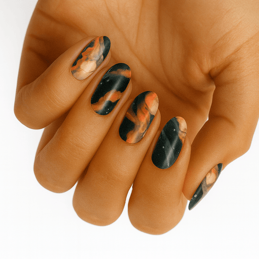 Marble effect nail wraps in terracotta orange and forest green on hand, stone pattern manicure