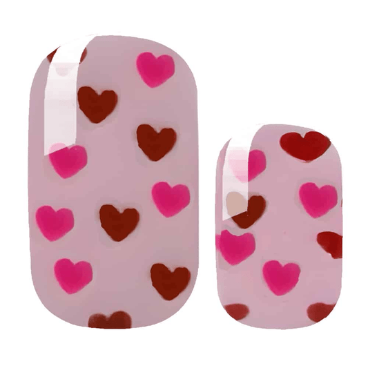 Pink nail wraps with red and burgundy heart pattern for romantic Valentine's Day manicure
