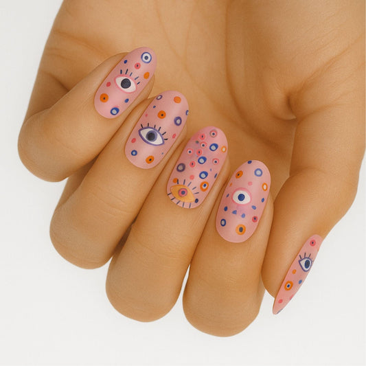 Pink nail wraps with all seeing eye design in blue and orange on hand