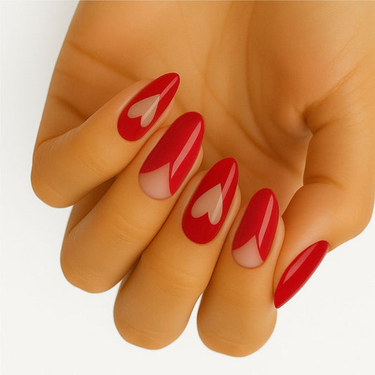 Red heart pattern nail wraps on hand showing romantic manicure design