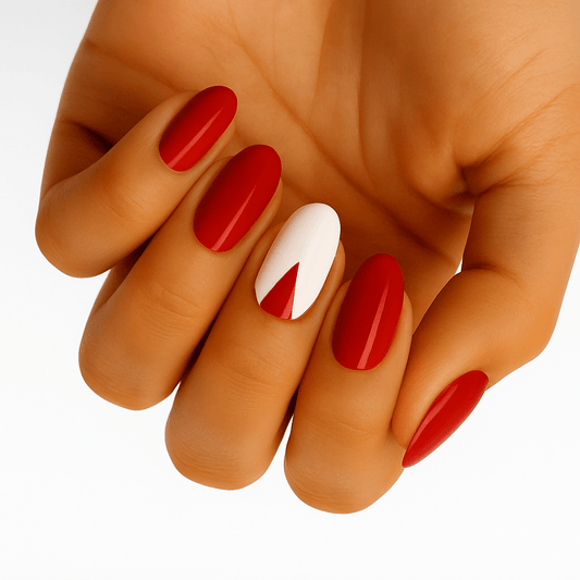 Red and white chevron pattern nail wraps on hand showing geometric arrow design