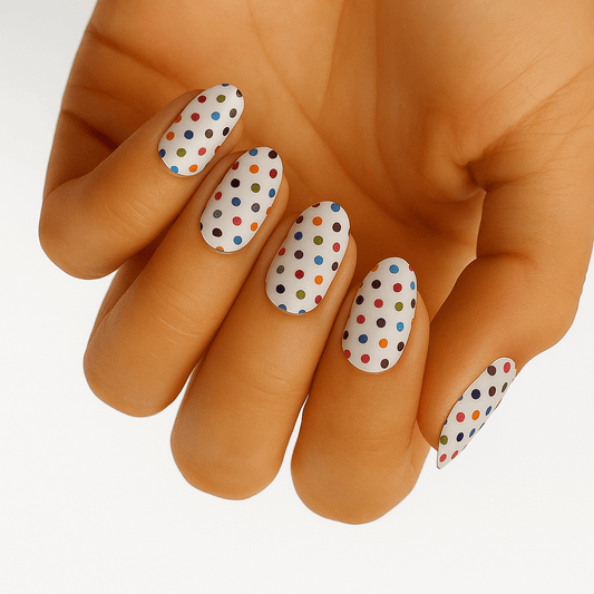 White nail wraps with colourful polka dots applied on hand showing rainbow spotted nail art design