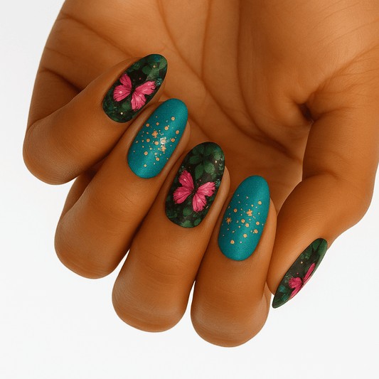 Turquoise and green nail wraps with pink butterfly patterns and gold glitter on hand