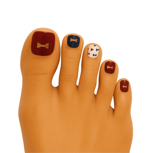 Autumn bowtie pedicure nail wraps on foot with orange burgundy pattern design