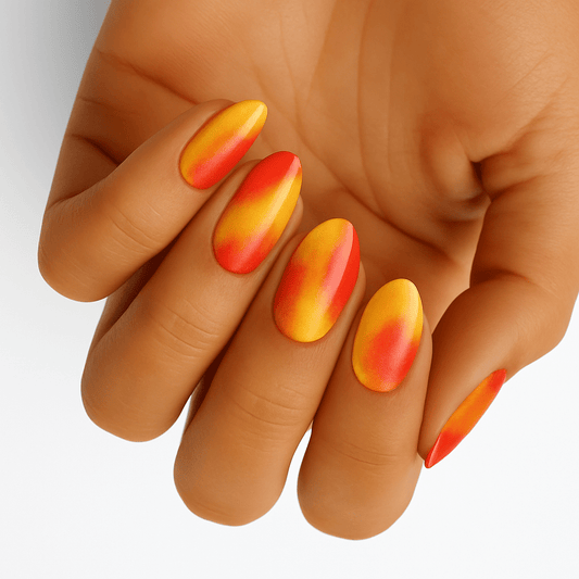 Orange to red gradient nail wraps on hand showing colour changing effect