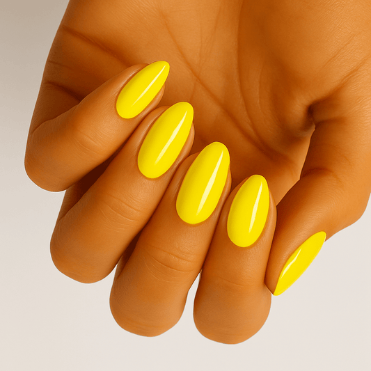 Bright yellow glossy nail wraps on hand displaying vibrant canary coloured manicure