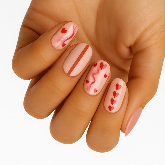 Pink nail wraps on hand with hearts dots and stripes valentine's day nail art