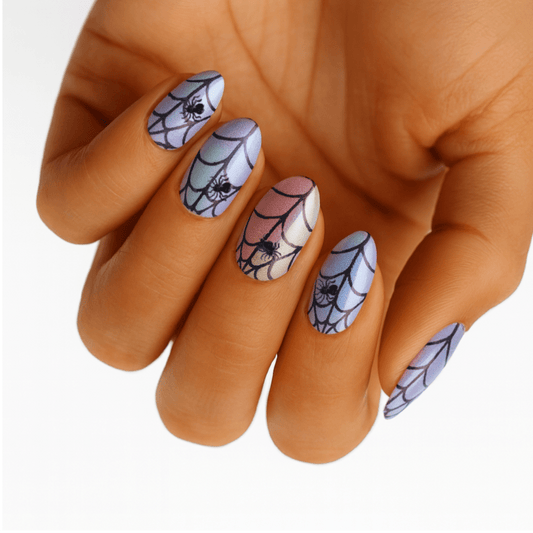 Holographic spider web nail wraps on hand showing gothic Halloween nail art design