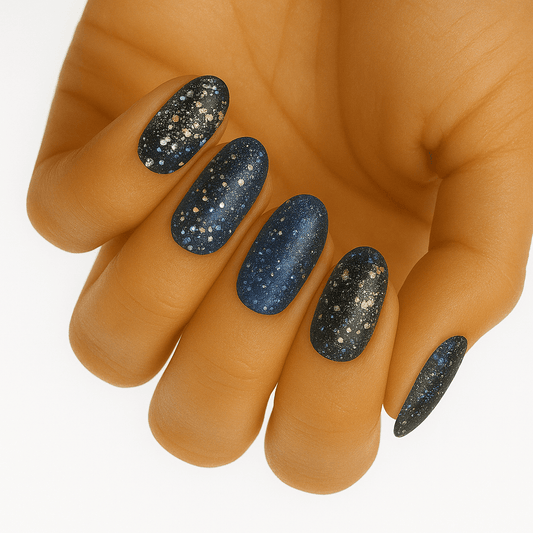 Blue glitter galaxy nail wraps on hand showing sparkly celestial design manicure