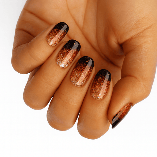 Copper gradient nail wraps on hand showing black to rose gold ombre nail art design