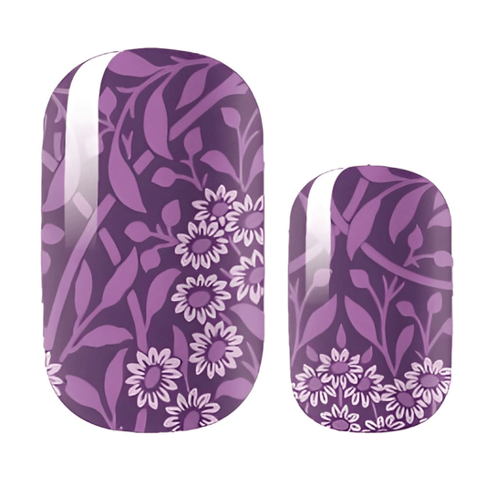 Purple nail wraps with dark botanical leaf pattern and white daisy flowers