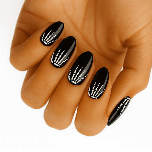Black nail wraps with white skeleton hand design for Halloween goth nail art