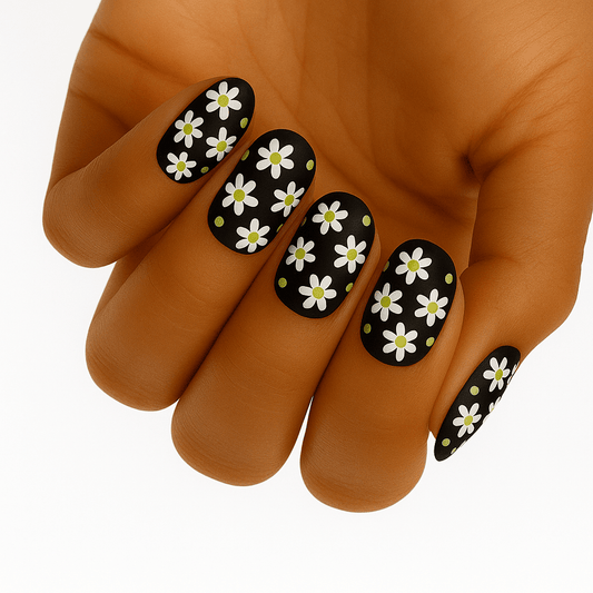 Black non-UV nail wraps with white daisy flowers and green dots on hand