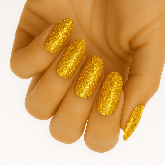 Golden glitter gel nail wraps on hand showing sparkling metallic finish for festive manicure