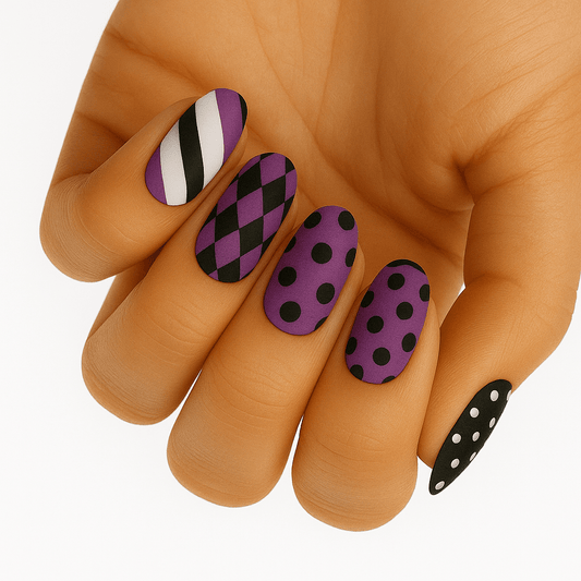 Purple and black geometric nail wraps with stripes, polka dots and checkerboard patterns on hand