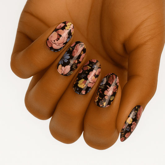 Dark floral nail wraps on hand featuring pink roses on black background