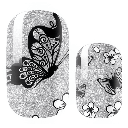 Silver glitter nail wraps with black butterfly patterns for elegant at-home manicure