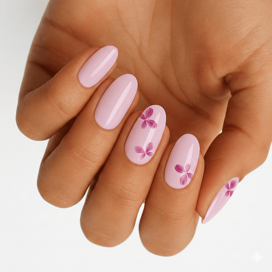 Pink butterfly nail art wraps on hand featuring delicate floral spring design