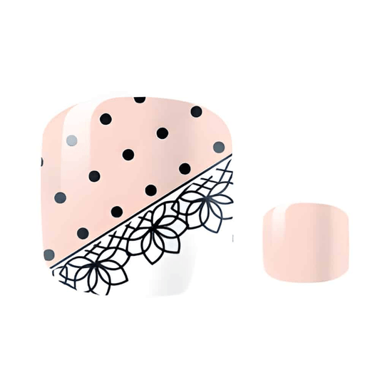 Pink polka dot pedicure nail wraps with black lace floral detail for toe nail art