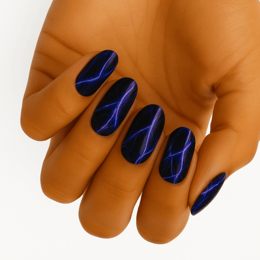 Black chrome nail wraps with blue lightning bolt pattern on hand showing electric design