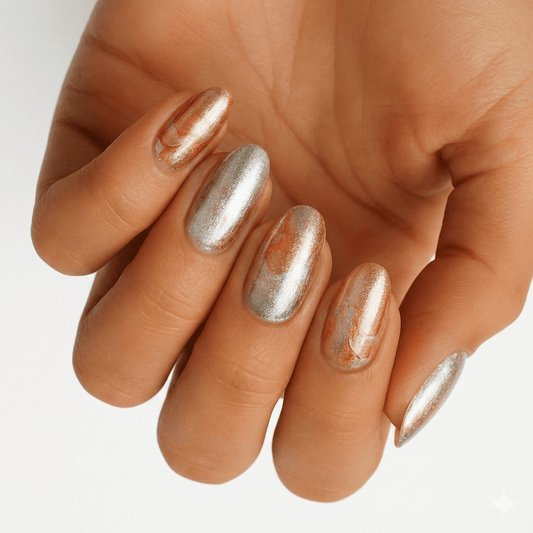 Chrome metallic nail wraps in gold and silver on hand showing mirror finish
