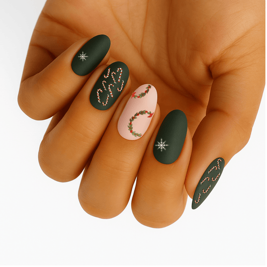 Green Christmas nail wraps with holly wreaths and snowflakes on hand festive holiday nail art