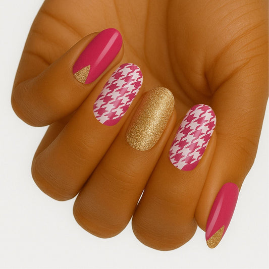 Pink houndstooth pattern nail wraps with gold glitter accent nails on hand showing mixed manicure design