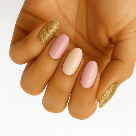 Hand displaying pink nude and gold glitter nail wraps in elegant neutral manicure design