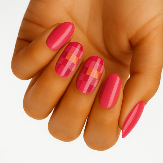 Pink coral gel nail wraps with pixelated geometric pattern on hand manicure