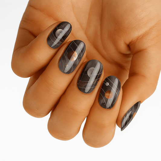 Chrome metallic nail wraps with geometric patterns on hand showing futuristic space-inspired nail art