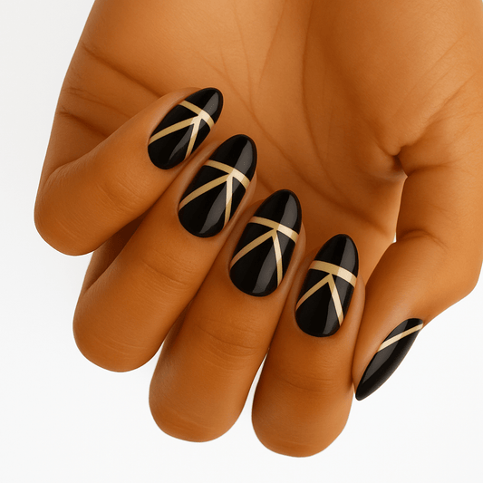 Black nail wraps with gold geometric art deco pattern on hand elegant manicure