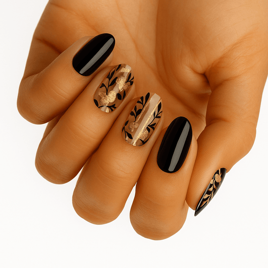 Black and bronze botanical nail wraps with metallic floral patterns on hand