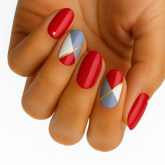 Red blue geometric nail wraps on hand featuring colour block pattern design