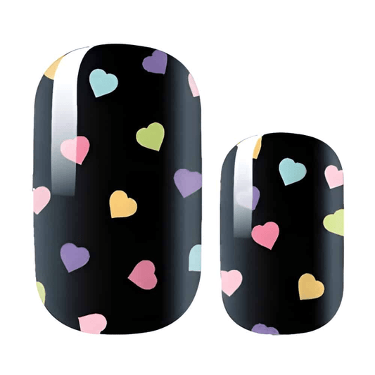 Black nail wraps with colourful heart pattern featuring pastel pink, purple, yellow and blue hearts