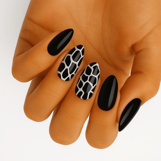 Black and white snake print nail wraps on hand showing animal print nail art