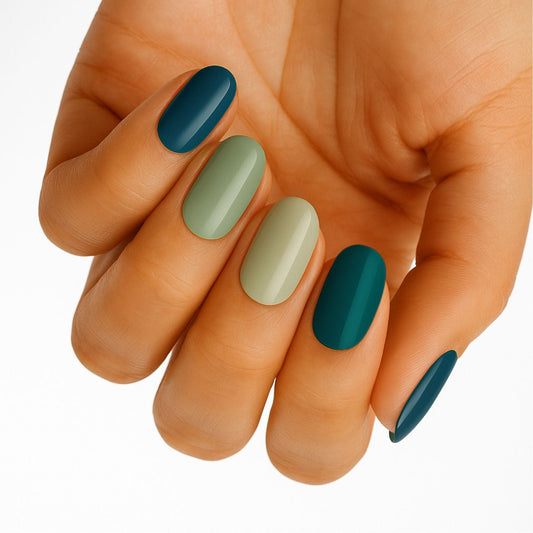 Blue and green ombre nail wraps on hand showing teal gradient manicure