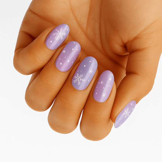 Purple glitter nail wraps with snowflake patterns on hand showing festive Christmas nail art