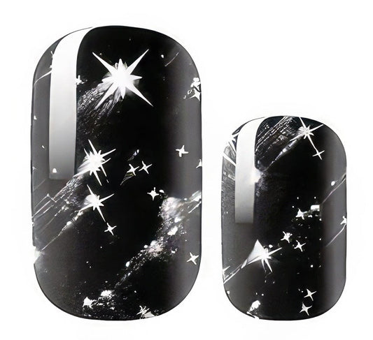 Black celestial nail wraps with silver stars and cosmic sparkle design