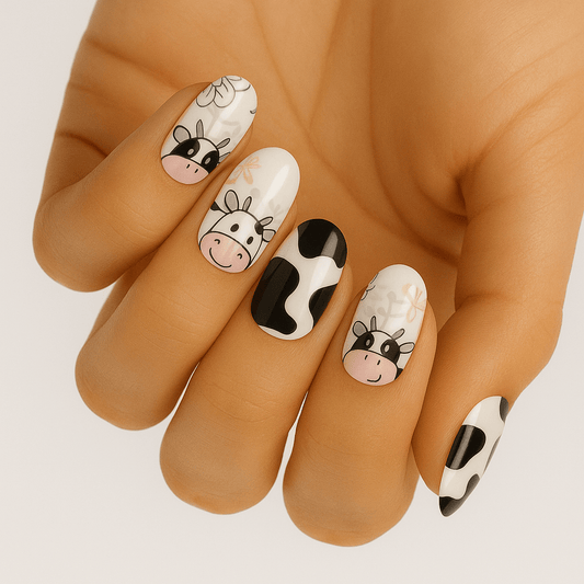 Cute cartoon cow nail art wraps on hand with black white spotted pattern