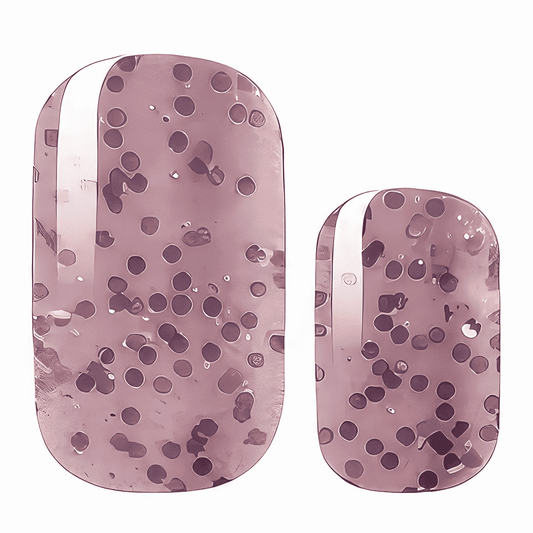 Mauve pink nail wraps with scattered dark purple dots in abstract speckled pattern