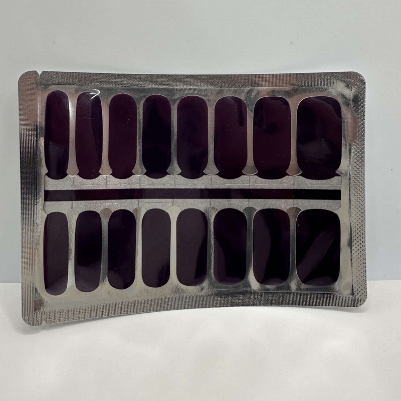 Deep mulberry purple nail wraps in packaging showing 16 solid colour strips for at-home manicure