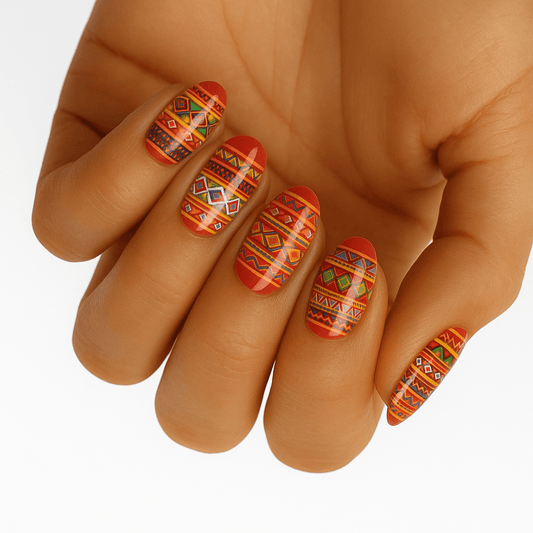 Red orange tribal geometric nail wraps on hand with southwestern aztec pattern design