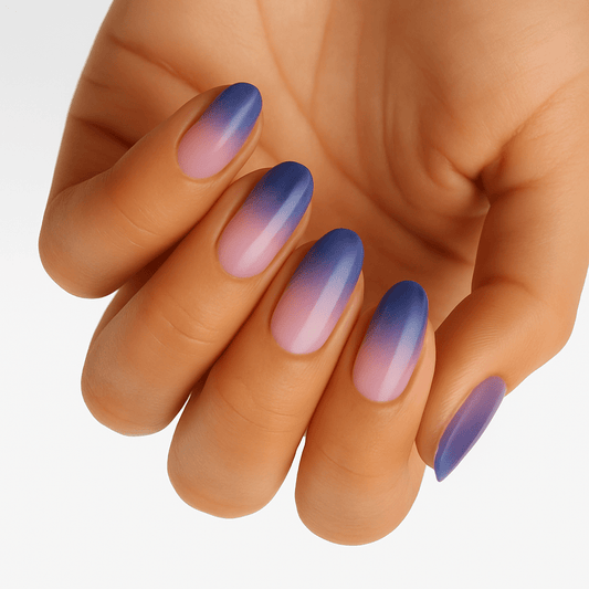 Purple to pink ombre gradient nail wraps on hand showing sunset colour transition