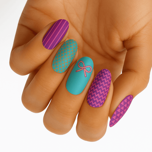 Colourful nail wraps on hand featuring purple geometric patterns and turquoise bow design